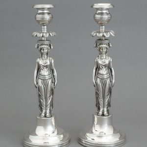 A PAIR OF SILVER CANDLESTICKS SHAPED AS CARYATIDS